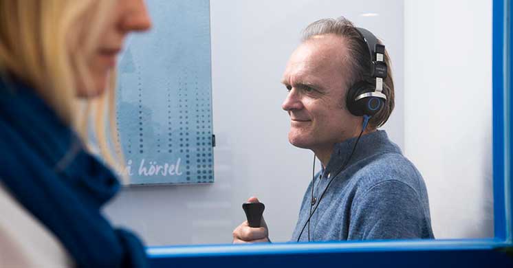 Man having a test - such as tone, speech, and word recognition tests 