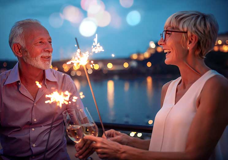Image show man and woman having glass of champagne at new year