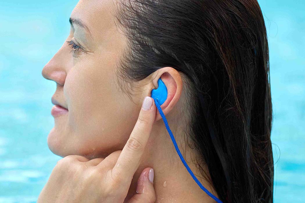Woman wearing swim earplugs