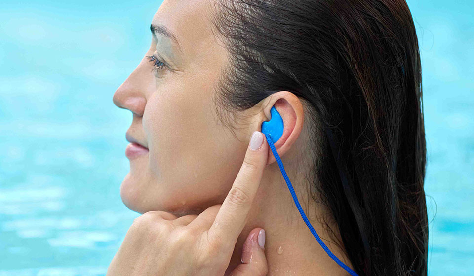 Woman wearing swim earplugs