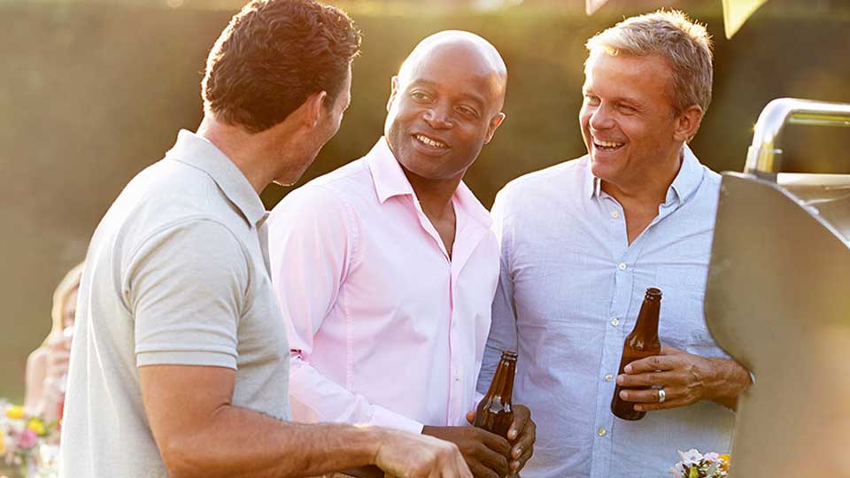 3 friends at a barbecue party with a beer