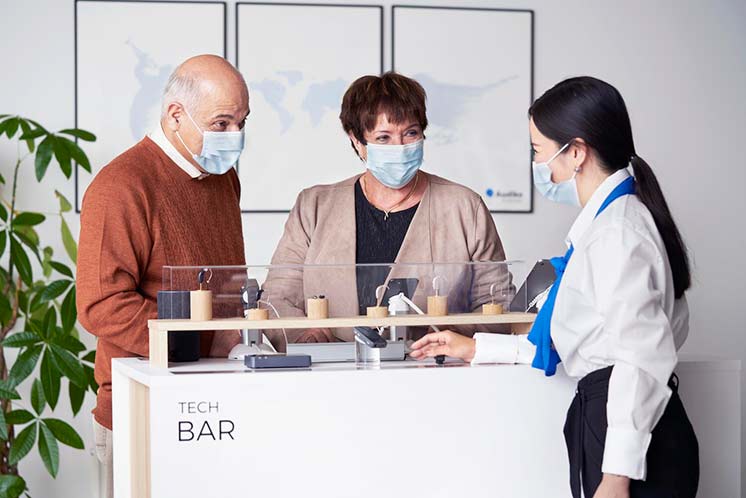 clients looking at hearing aid types in hearing clinic with hearing professional