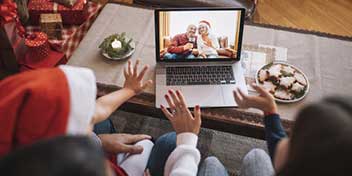 Family video calling grandparents during holiday celebration, illustrating how hearing aids support meaningful connections.