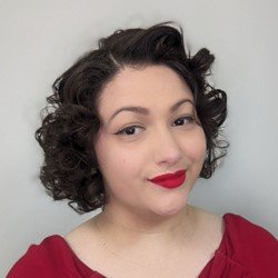 Kim Letendre, hearing care specialist with short curly hair wearing a red top.