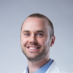 Paul Max, hearing care professional, wearing a white coat.
