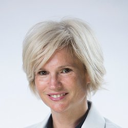 Shirley Monk with short blonde hair and a light background