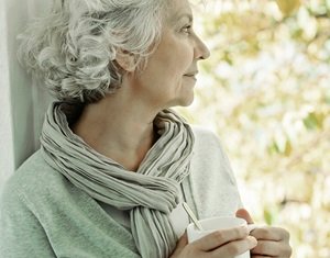 Image show woman looking outside window