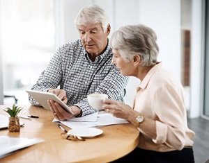 Image show couple looking at a tablet