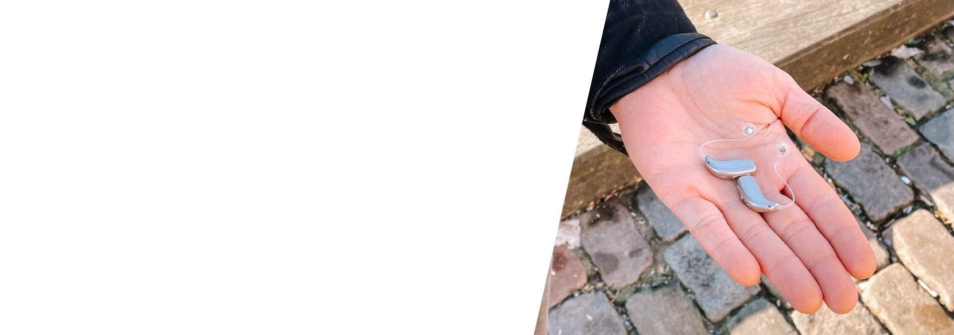 Hand holding tinnitus hearing aids