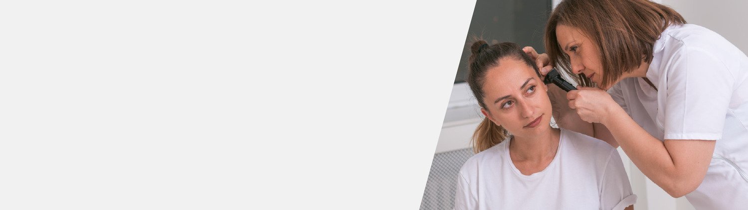 audiologist examining ear before earwax removal