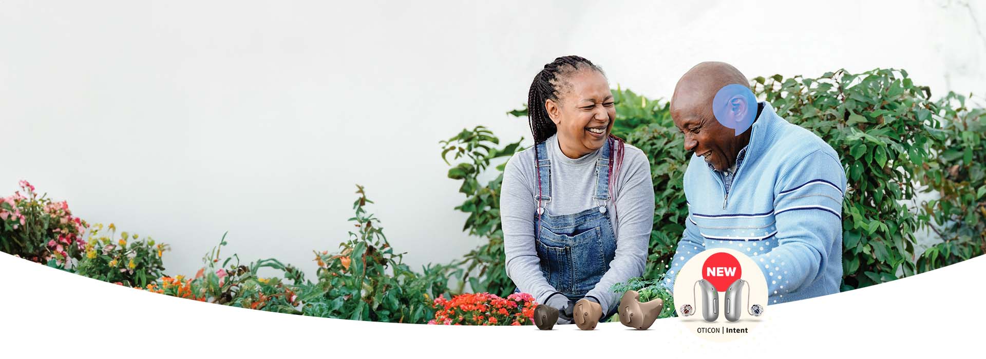 man gardening with woman and using hearing aid