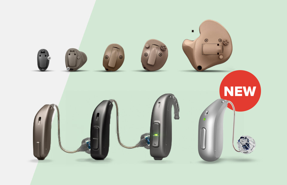Various hearing aids are displayed, including in-the-ear and behind-the-ear models. The newest behind-the-ear design, marked ’NEW’ in a red circle, features a sleek silver finish.