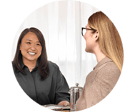 Woman wearing Oticon Zeal hearing aid sitting down, talking to her friend