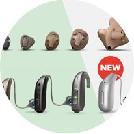 Various hearing aid models are displayed on a split green-and-white background, including discreet in-ear and behind-the-ear designs. A ’NEW’ label highlights a sleek silver behind-the-ear model. No text present.