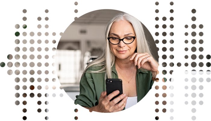 A woman with long gray hair, wearing a green shirt, holds a smartphone while seated in a modern indoor setting. The image features a circular frame with decorative soundwave motifs. No text is present.