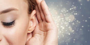 Hand cupped to ear with glittery sound waves flowing toward it.