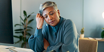 Tired woman struggling with concentration at her desk