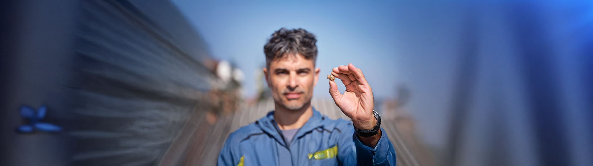 man showcasing a modern hearing aid