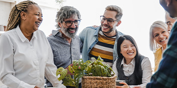 People sharing smiles and enjoying a lively conversation in a social gathering.