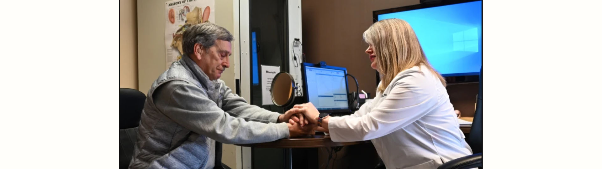 hearing care specialist consulting a patient in a modern clinic environment