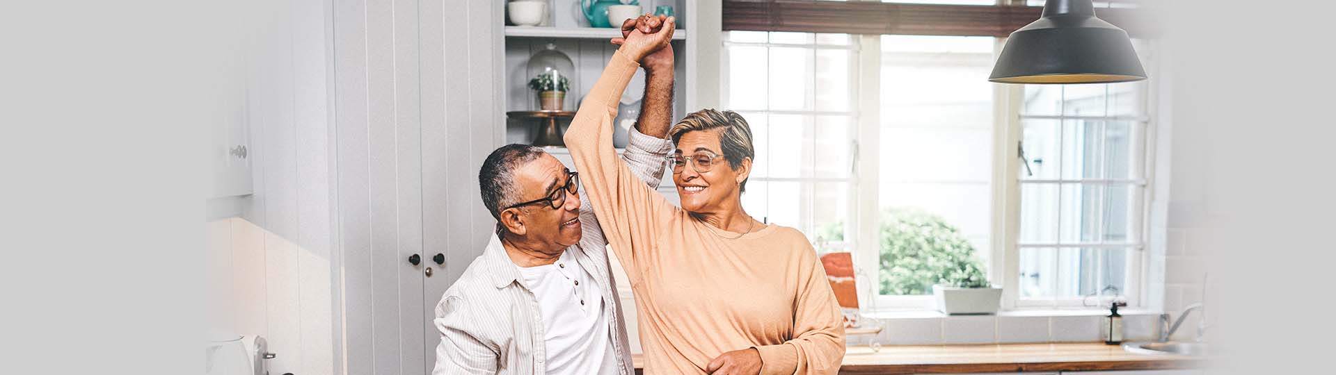 Two mature people dancing and smiling