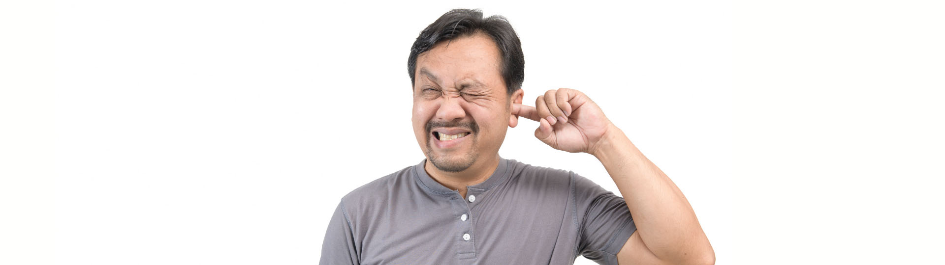 person scratching their ear while squinting due to discomfort
