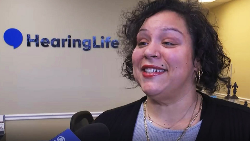 woman talks about hearing aids and advocacy at HearingLife clinic