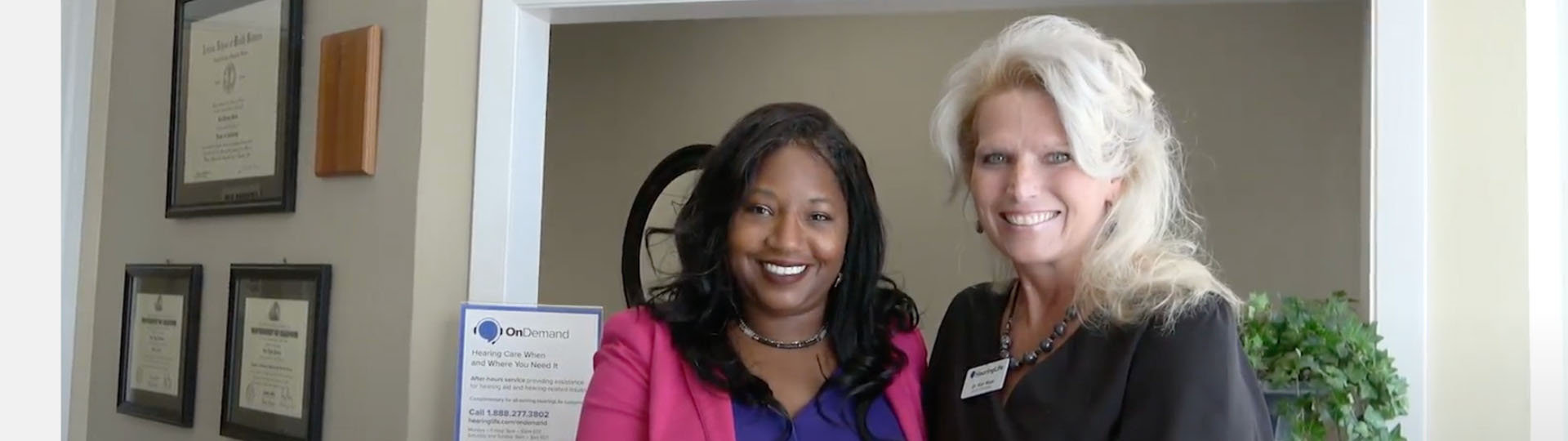 Sydney Holman and audiologist Dr. Maas in a professional hearing care clinic environment.