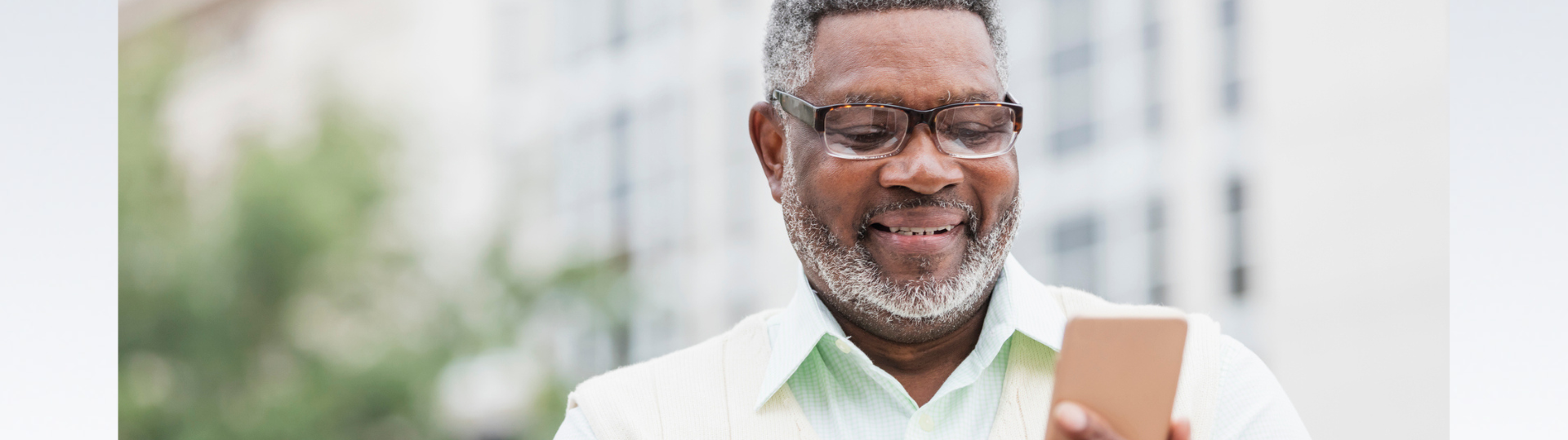 a man looking at his phone and smiling