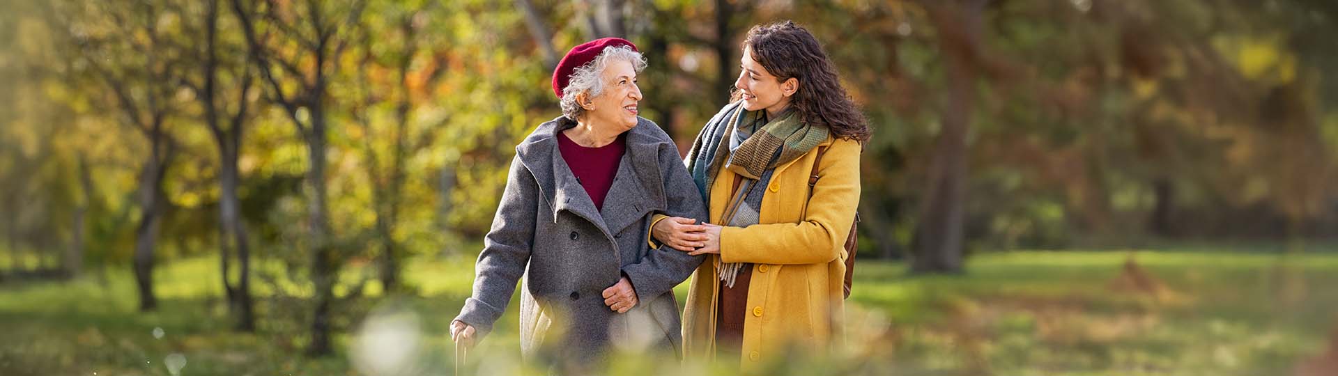 two women smiling and walking outside