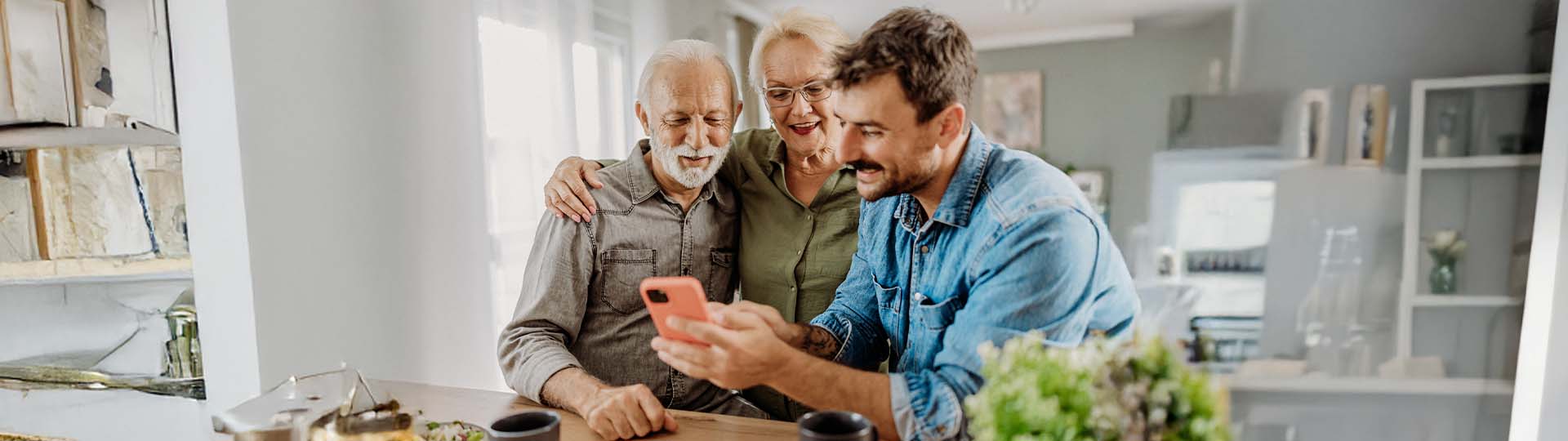 man discussing hearing aids with his parents