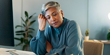 Tired woman resting her head on her hand