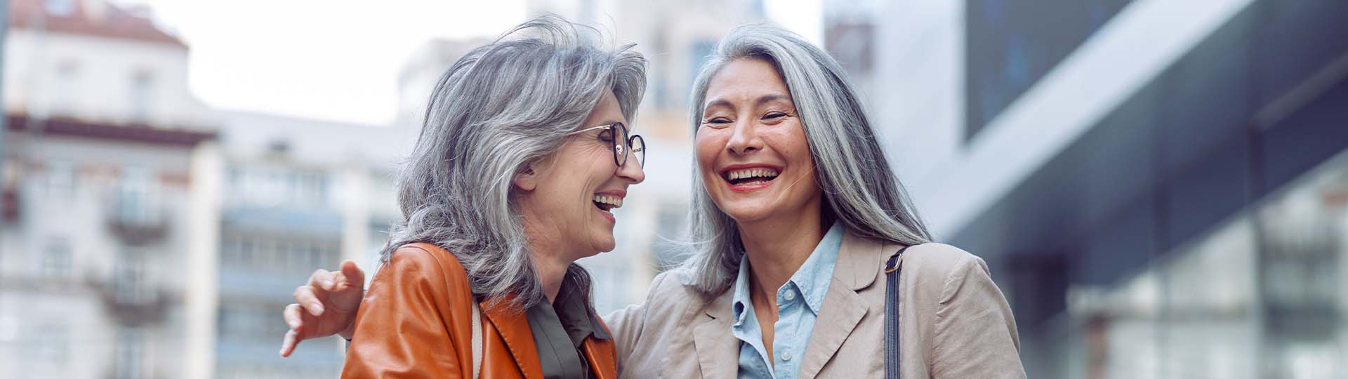Two friends smiling and talking to each other