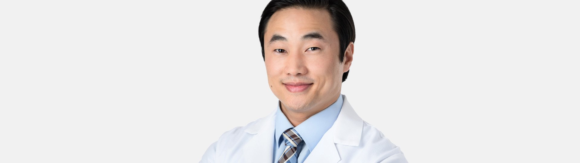 dr agrusa professional audiologist in a white coat promoting compassionate hearing care