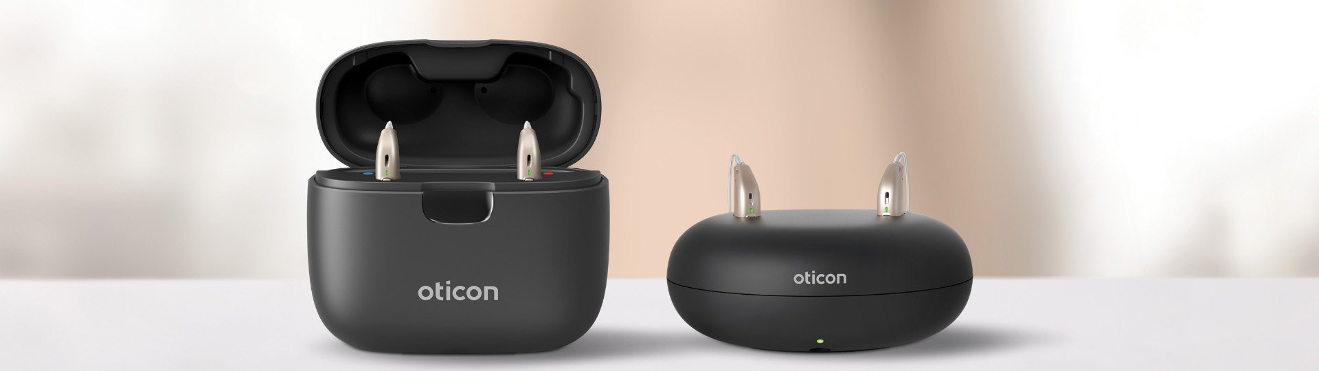 oticon real rechargeable hearing aids placed in black charging cases