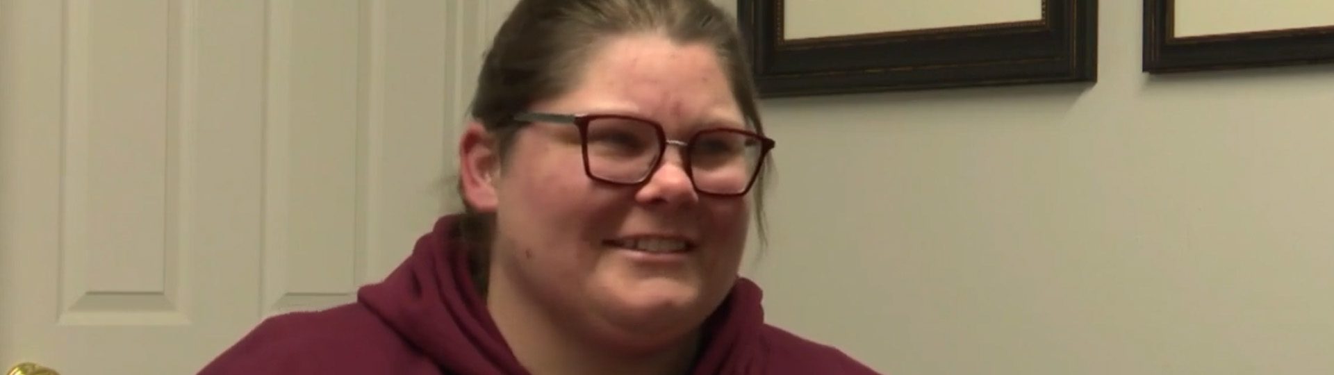 Sabra happily receives her new hearing aids at a hearing care clinic.