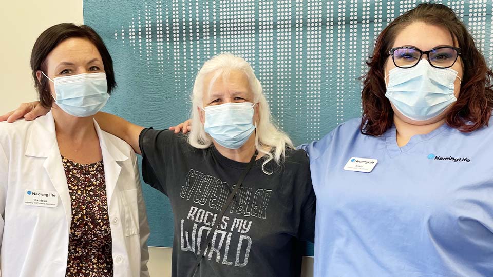 Woman benefits from free hearing aids provided by the Campaign for Better Hearing initiative.