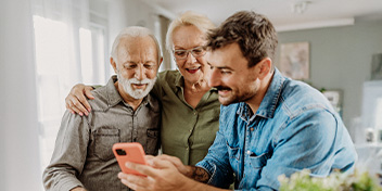 man sharing information about hearing aids with his parents
