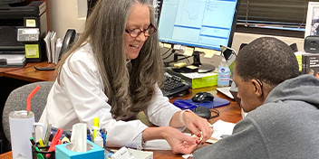 Hearing care specialist assisting a man in choosing hearing aids at HearingLife