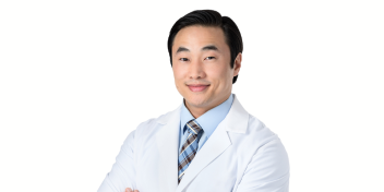 Compassionate audiologist wearing a white lab coat and professional attire