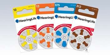 hearing aid batteries with color-coded packaging in sizes 10, 13, 675, and 312