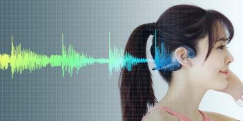 woman wearing bone conduction headphones with colorful soundwave graphic on a grid background