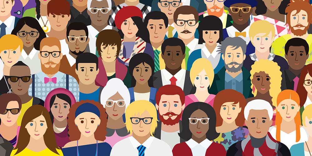 A diverse group of people with varied hairstyles, clothing, accessories, and personal styles stand closely together, highlighting cultural and individual uniqueness against a plain backdrop.