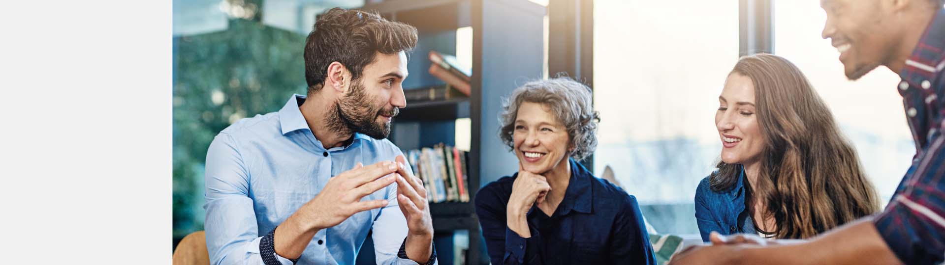 people of varying ages having a lively discussion in a bright, modern environment