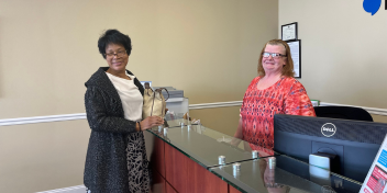 Mayor of Braddock, Pennsylvania, at a HearingLife clinic receiving complimentary hearing aids.