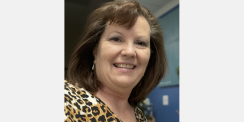 HearingLife patient care coordinator standing in an office setting