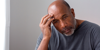 Man expressing discomfort associated with tinnitus