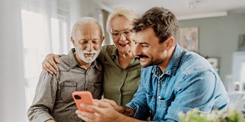 man discussing hearing aids with his parents