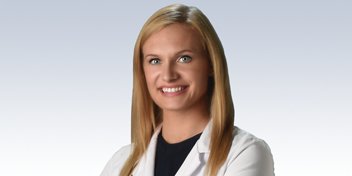 Dr. Bavaro, hearing care professional in a white lab coat