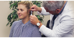 a woman getting her ears looked at